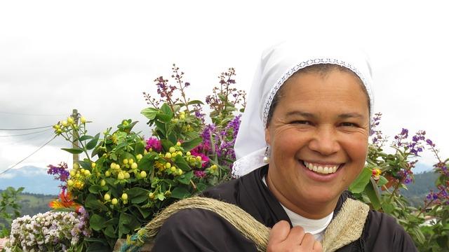 Mujer sonriente cargando flores en el Oriente antioqueño