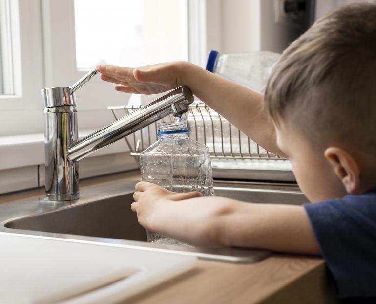 Niño aprendiendo a ahorrar agua en casa