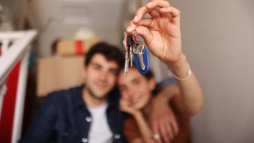 Una pareja sostiene las llaves de su casa, adquirida gracias a proyectos VIS en Bogotá.