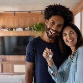  pareja de esposo y esposa sosteniendo las llaves de su casa después de la compra de vivienda nueva.